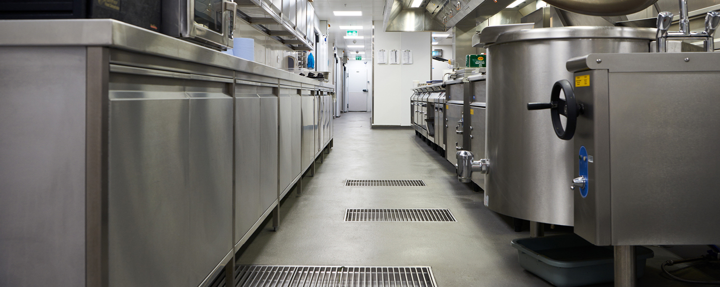 A commercial kitchen with a resin floor